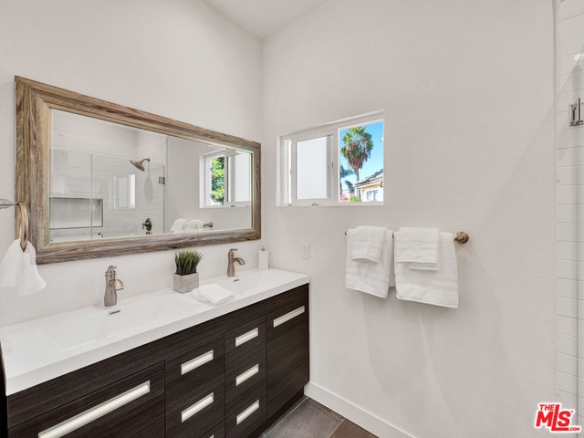 bathroom with an enclosed shower and vanity