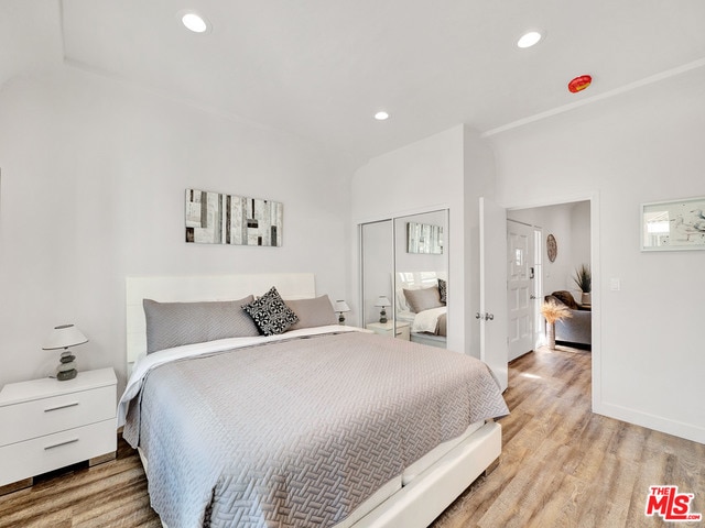 bedroom featuring light hardwood / wood-style floors and a closet