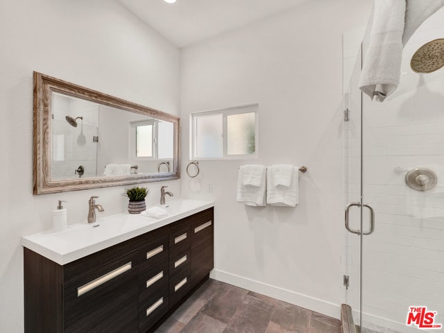 bathroom with vanity and an enclosed shower