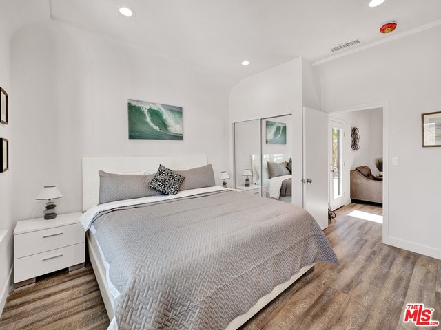 bedroom featuring hardwood / wood-style flooring and a closet