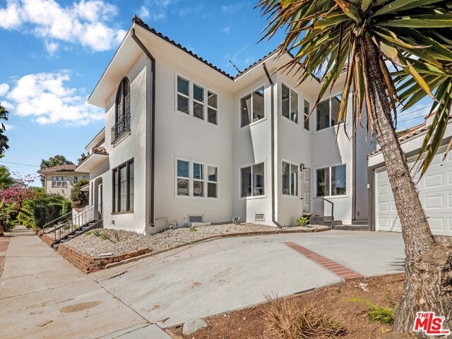 rear view of property featuring a garage