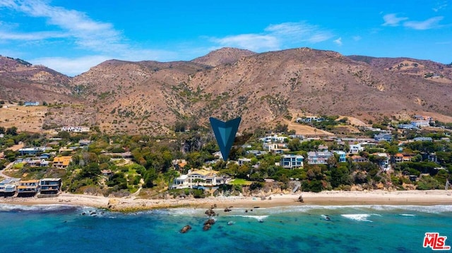 bird's eye view with a view of the beach and a water and mountain view