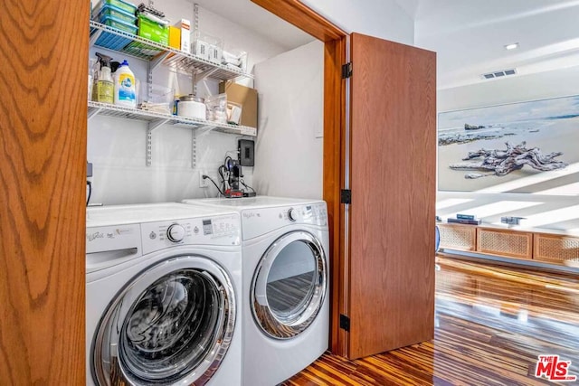 washroom featuring hardwood / wood-style flooring and washer and clothes dryer