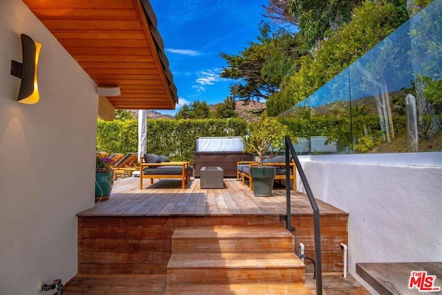 wooden terrace with a hot tub