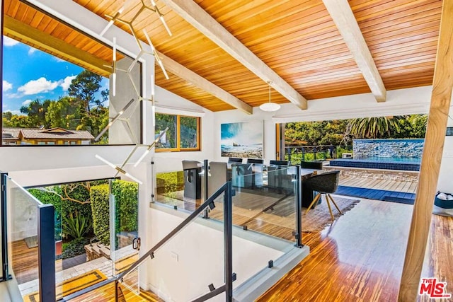 interior space with wood ceiling and lofted ceiling with beams