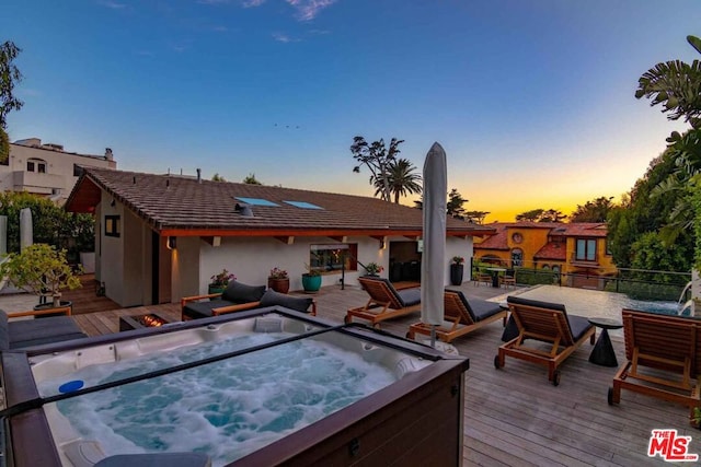 exterior space featuring a hot tub and a deck