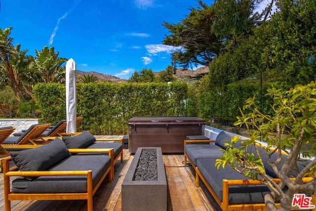 view of patio featuring a hot tub and a fire pit