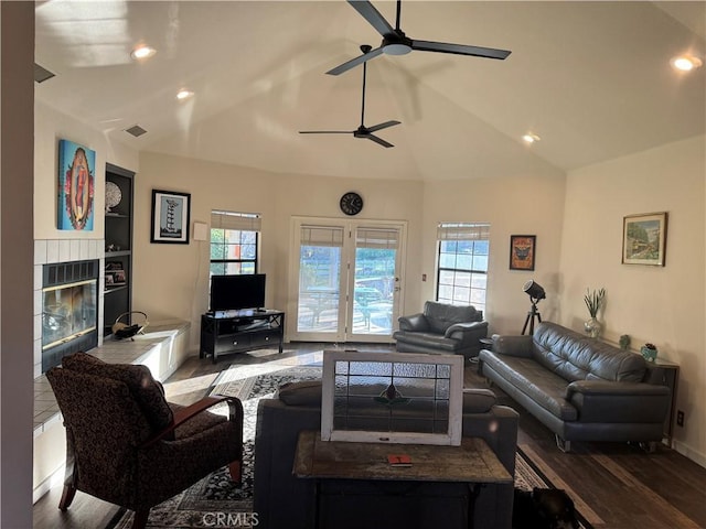 living room featuring a healthy amount of sunlight, vaulted ceiling, and visible vents