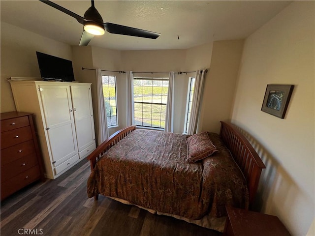 bedroom featuring ceiling fan and dark wood finished floors