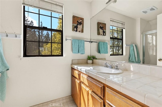 full bath with vanity and a stall shower