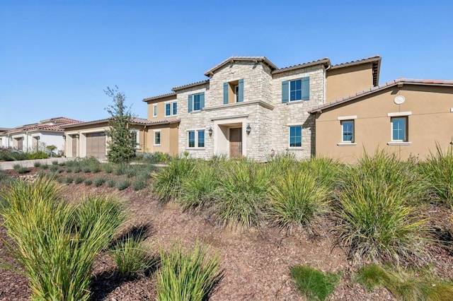 mediterranean / spanish house with a garage