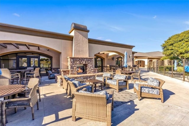 view of patio / terrace with an outdoor stone fireplace and french doors