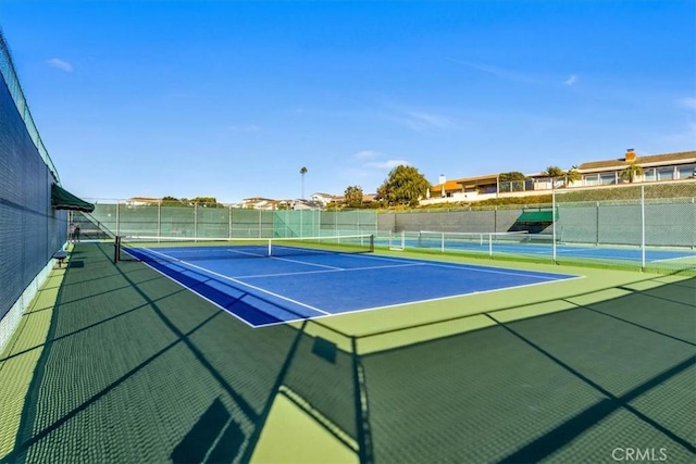 view of tennis court featuring basketball court