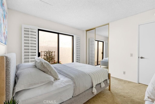 carpeted bedroom with a closet and a textured ceiling