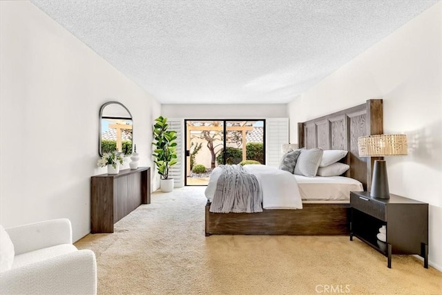 bedroom with light carpet, access to exterior, and a textured ceiling