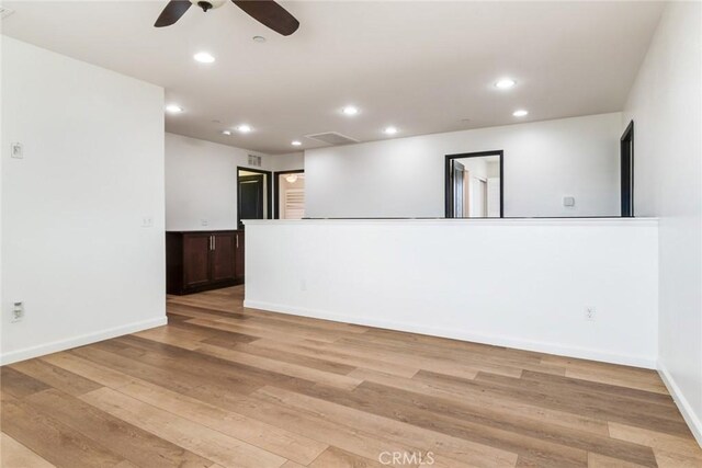 empty room featuring ceiling fan and light hardwood / wood-style floors