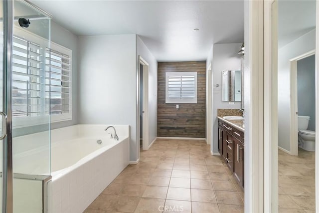 full bathroom featuring wooden walls, separate shower and tub, vanity, tile patterned floors, and toilet