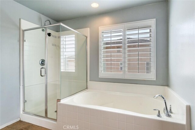 bathroom with plenty of natural light and shower with separate bathtub