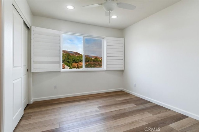 unfurnished room with ceiling fan and light hardwood / wood-style flooring