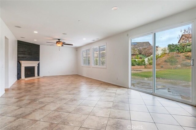 unfurnished living room with light tile patterned flooring and a healthy amount of sunlight