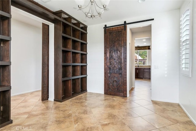 interior space featuring a barn door, light tile patterned floors, and a notable chandelier