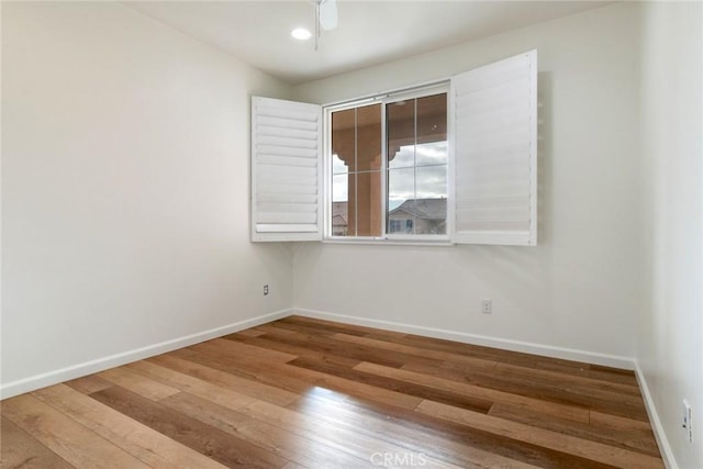 unfurnished room with hardwood / wood-style flooring