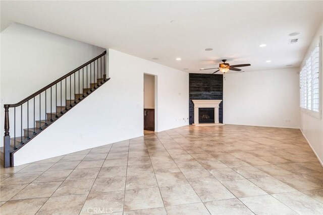 unfurnished living room with light tile patterned floors and ceiling fan