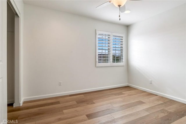 spare room featuring ceiling fan and light wood-type flooring