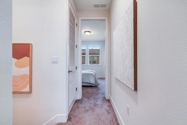 hallway featuring light carpet