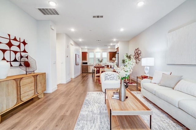 living room with light hardwood / wood-style flooring