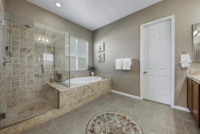 bathroom featuring vanity, plus walk in shower, and tile patterned flooring