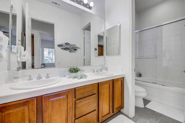 full bathroom with vanity, toilet, and combined bath / shower with glass door