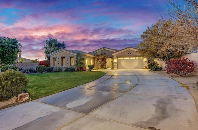 view of front of home with a garage and a lawn