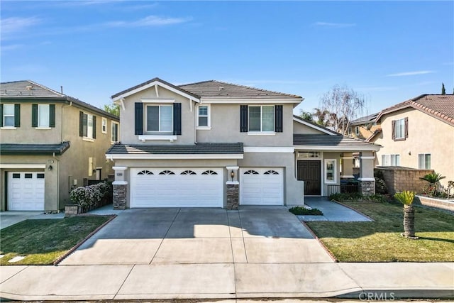 view of property featuring a garage and a front yard