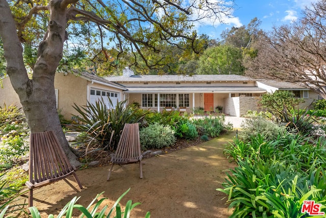 back of property featuring a garage