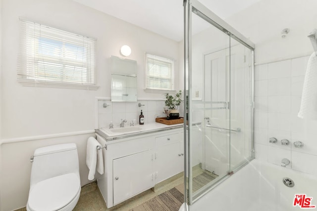 full bathroom with vanity, backsplash, shower with separate bathtub, and toilet