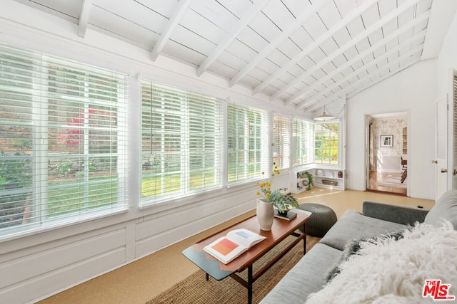 sunroom / solarium featuring lofted ceiling with beams and wood ceiling