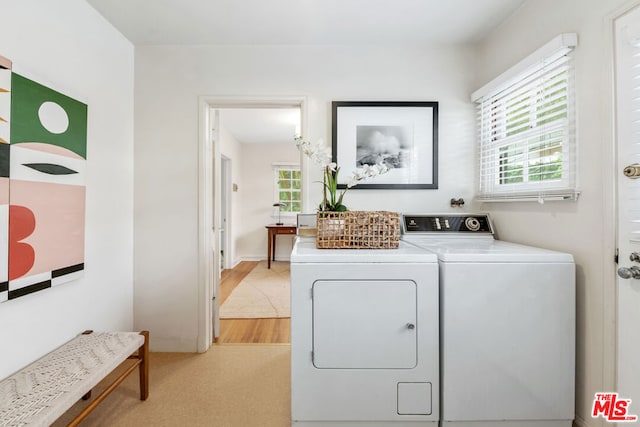 laundry room featuring light hardwood / wood-style flooring and independent washer and dryer