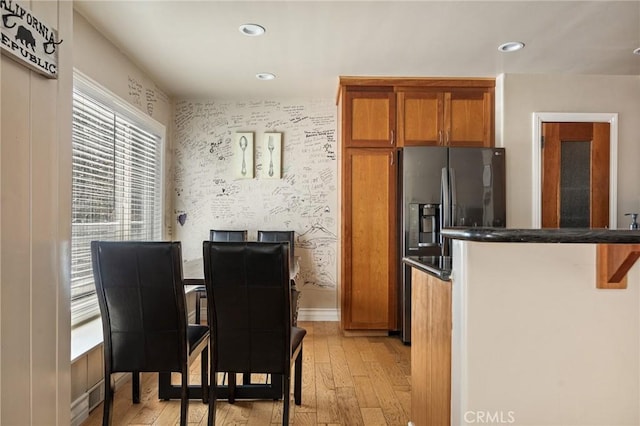 kitchen with refrigerator with ice dispenser and light hardwood / wood-style flooring