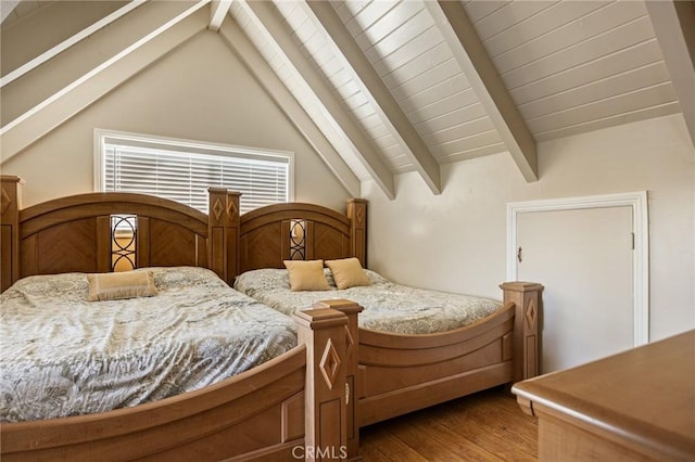 bedroom featuring vaulted ceiling with beams and hardwood / wood-style floors