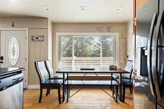 dining space with light hardwood / wood-style floors