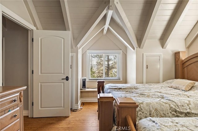 bedroom featuring light hardwood / wood-style floors and lofted ceiling with beams