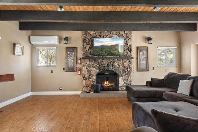 living room featuring hardwood / wood-style floors, beam ceiling, a wall mounted AC, a fireplace, and wooden ceiling