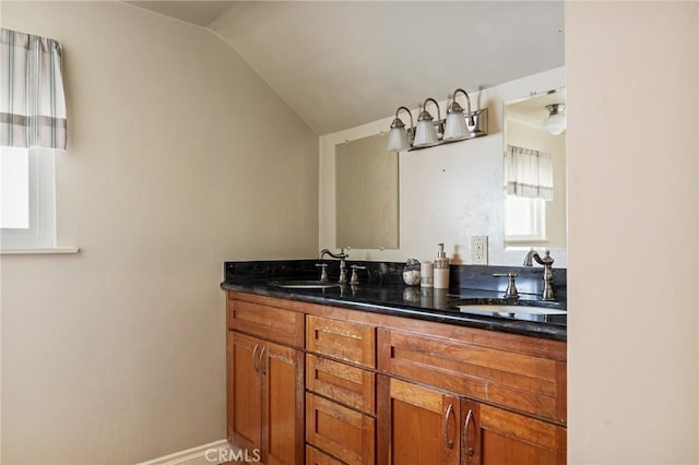 bathroom with vanity and vaulted ceiling