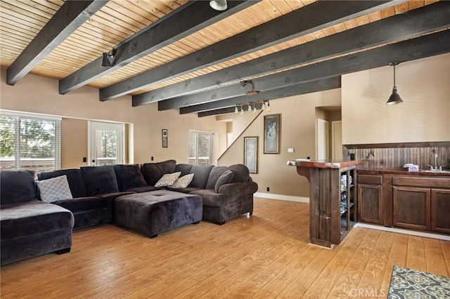 living room with beam ceiling, light hardwood / wood-style flooring, and wooden ceiling