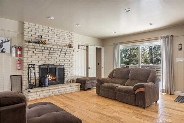 living room featuring a fireplace and light wood-type flooring