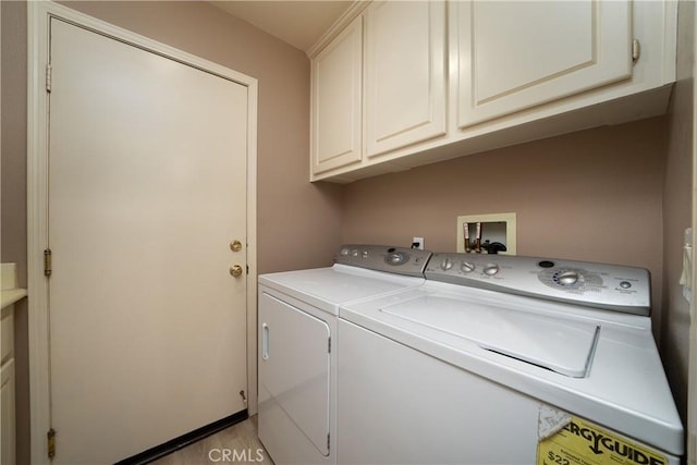 washroom featuring cabinets and separate washer and dryer