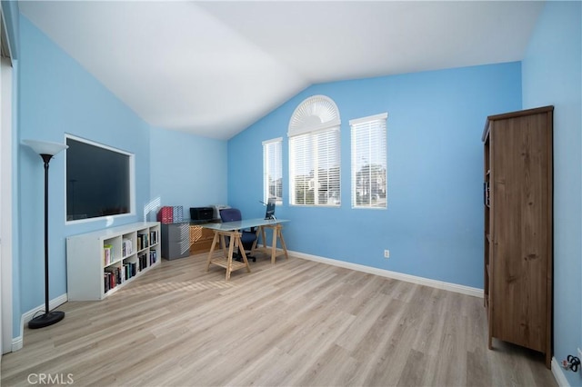 office space featuring lofted ceiling and light hardwood / wood-style floors