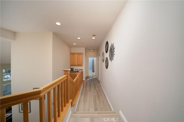 corridor with light hardwood / wood-style flooring