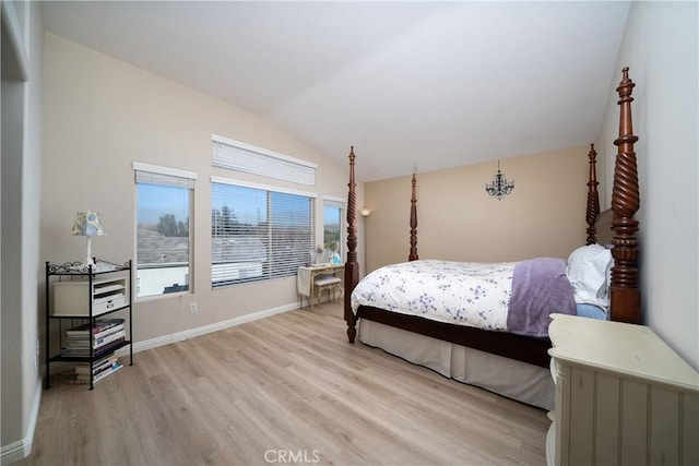 bedroom with lofted ceiling and light hardwood / wood-style flooring